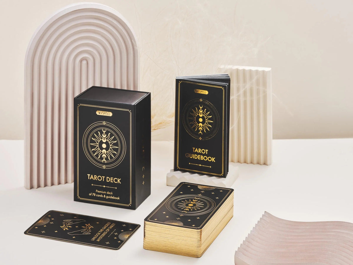 Tarot deck packaging with cards on a neutral background