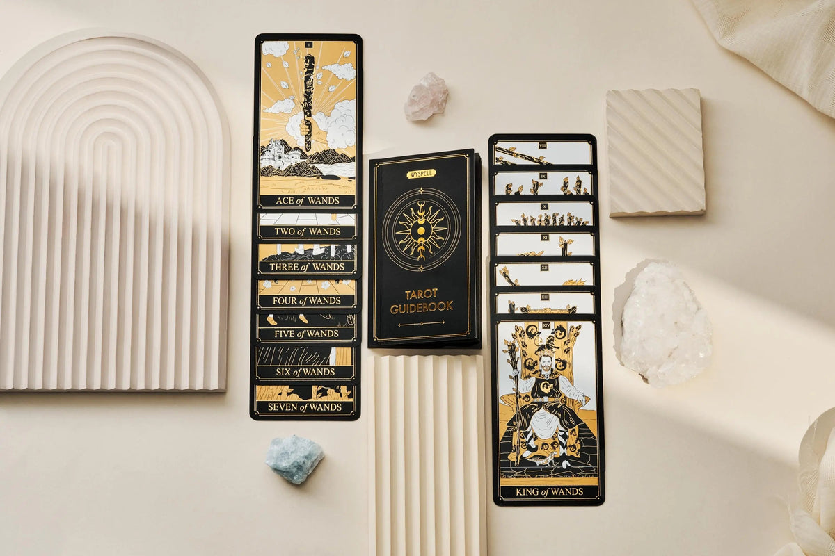 Tarot card set with book and cards on a neutral background